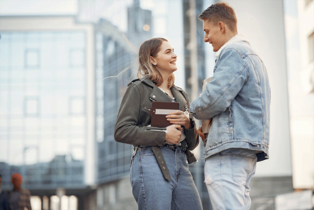 man and woman talking on street