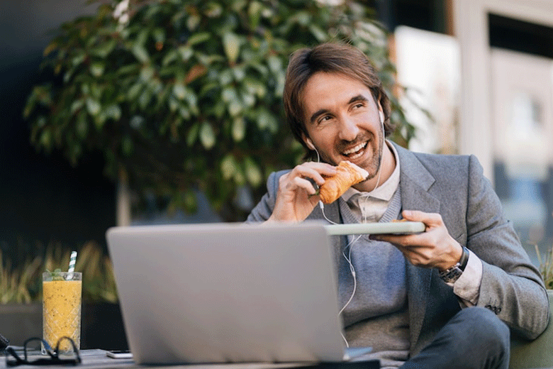 man eating lunch during meeting