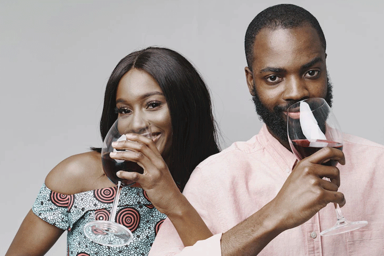 Man share glass of wine with his woman