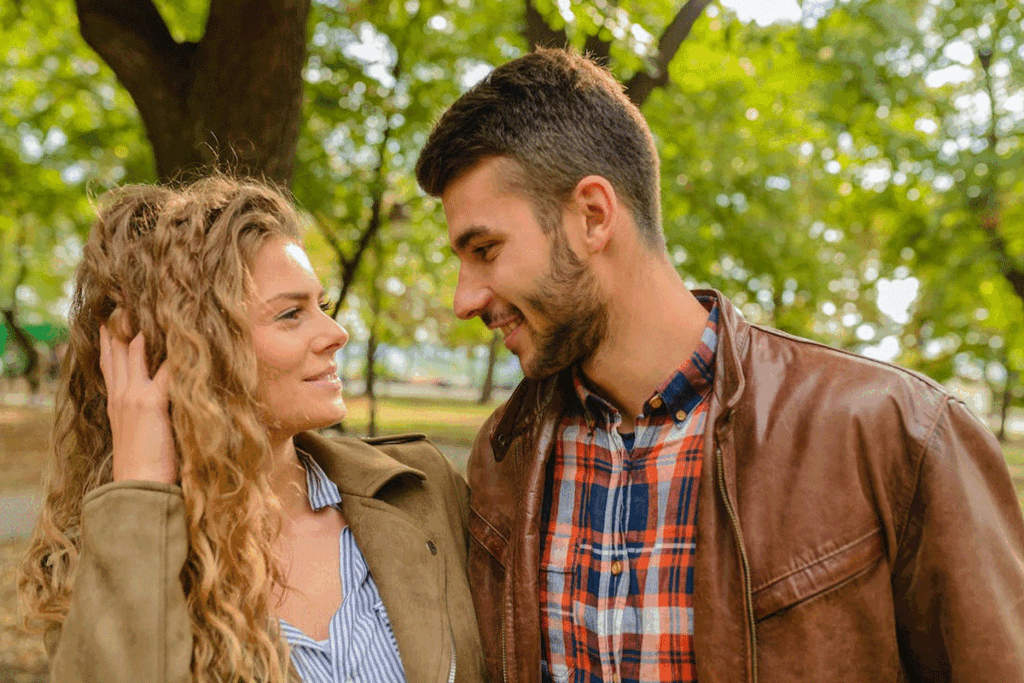 A man attractively smiles at a woman